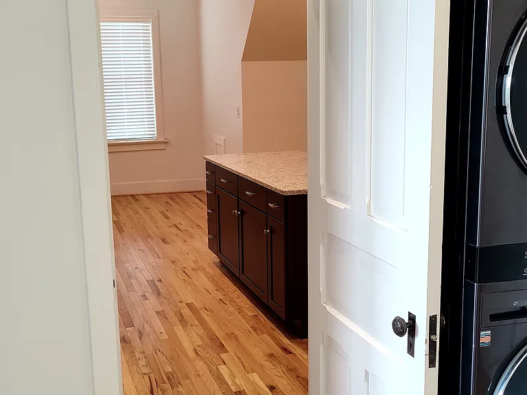 View from just inside the apartment door looking South to kitchen.