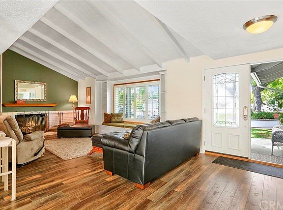 Living room and entry with beamed ceilings