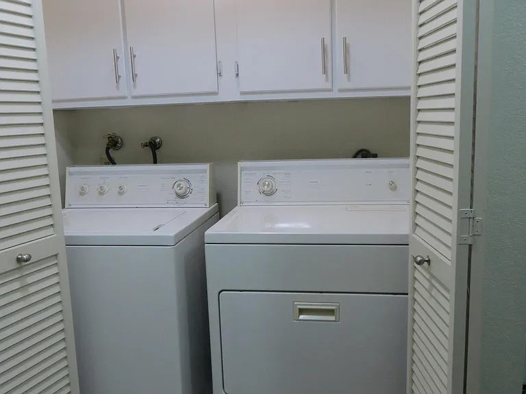 Laundry area, off hallway; newly painted cabinets, new cabin