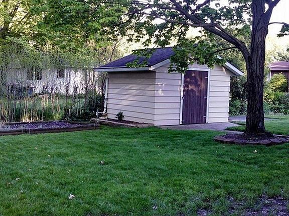 Garden Shed with electricity, has a garden to the left, patio to right of shed.