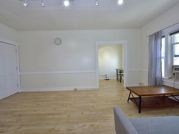 updated LARGE studio with many windows, furnished with in-unit laundry machines