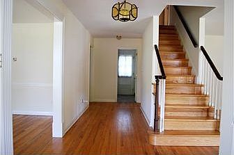 Center hall foyer with exposed hardwood floors