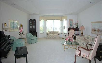 Showcasing a lovely bay window and room enough for a piano...