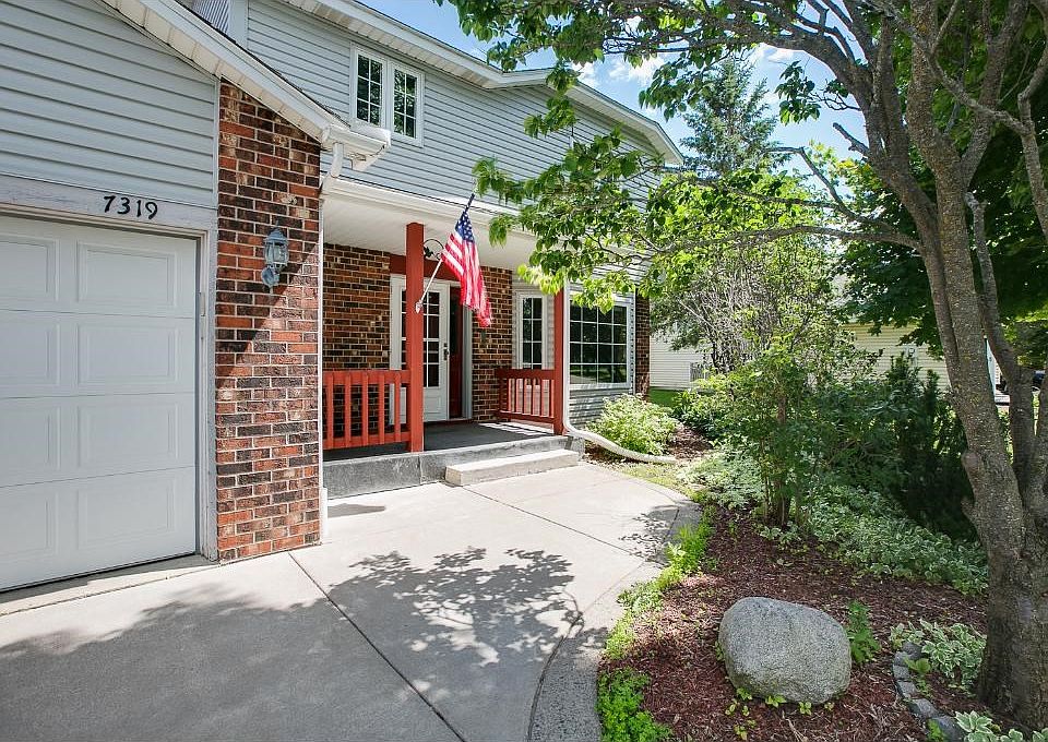 Beautiful concrete driveway and walkway leads you to the front door.
