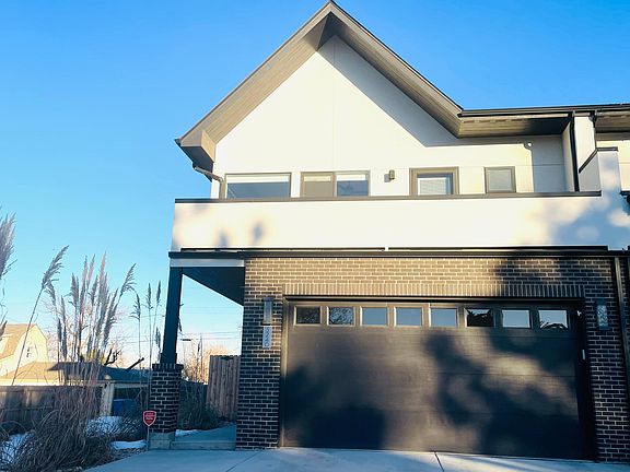 front of house with balcony from primary bedroom