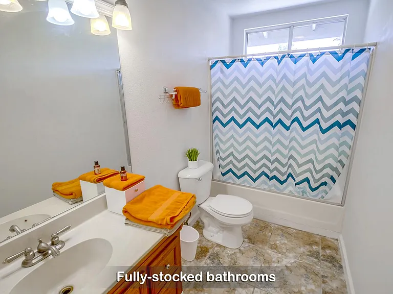 efresh in the fully stocked bathroom with soap, shampoo, and a hairdryer.