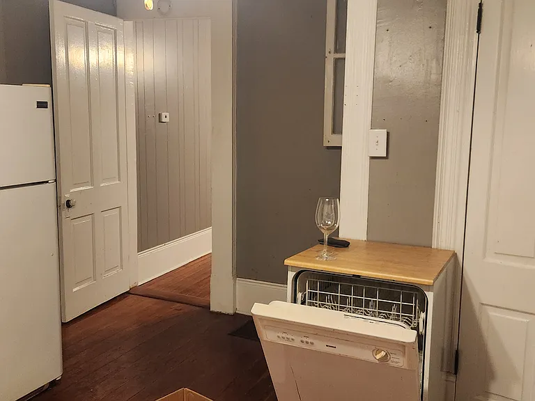 Kitchen looking into living dining room. Laundry at right side.