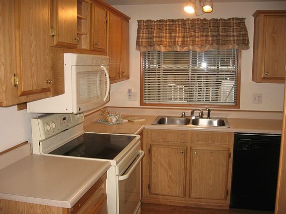 Another close up of kitchen with almost new microwave.