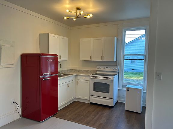 Brand new kitchen cabinets, handles, sink, faucet, countertops, new lighting, and brand new retro fridge