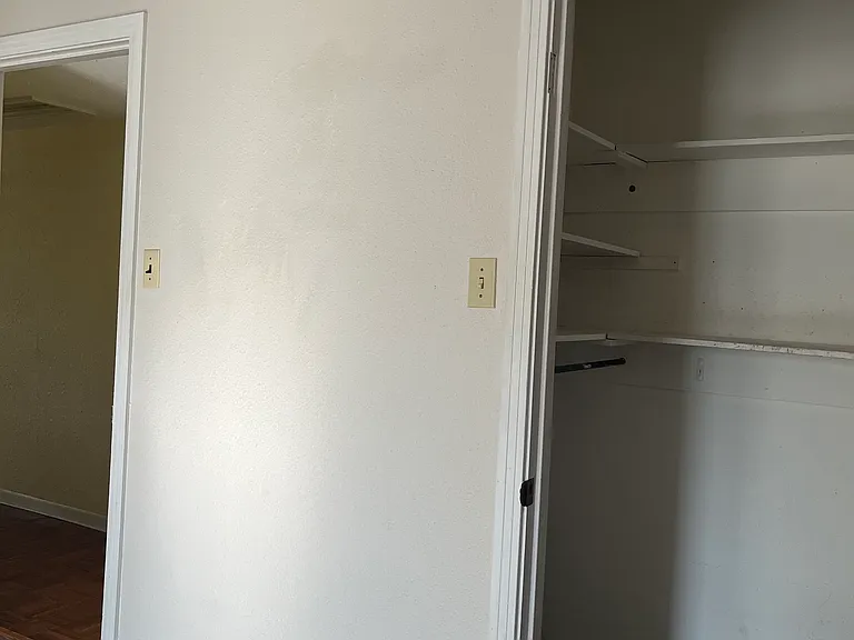 Master closet with high and low hanging rods plus shelving