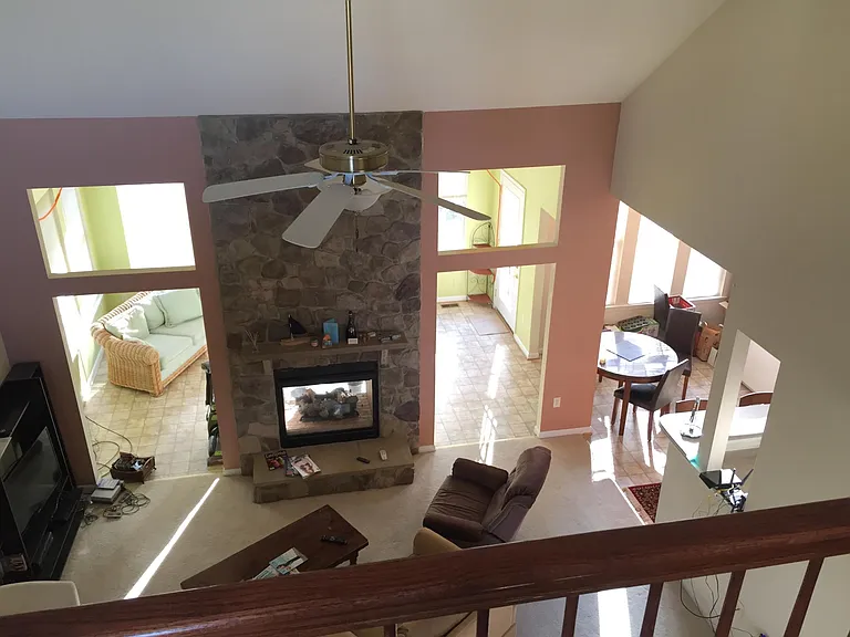 Living room, and sunroom in back viewing from balcony