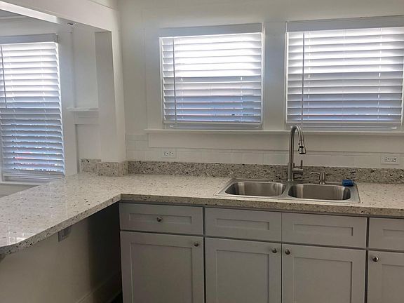 Kitchen: Double sink with sprayer and cupboards