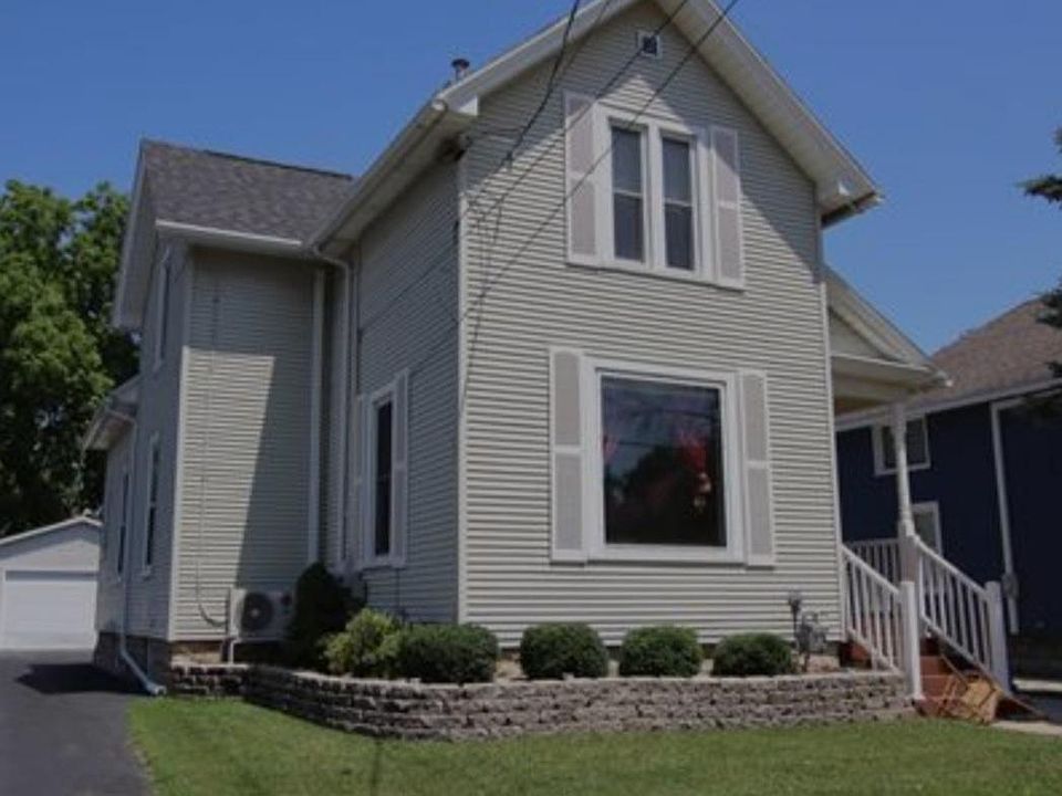 Lower unit front porch with garage behind house.