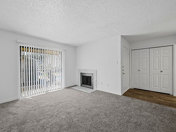 Spacious open floor plan with sliding door and fireplace