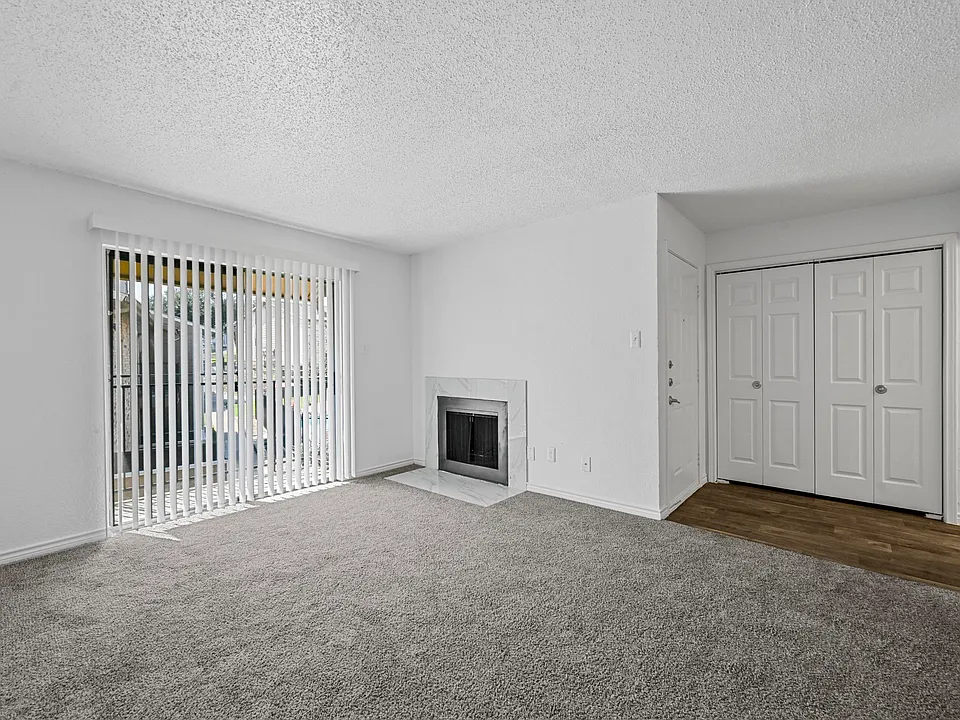 Spacious open floor plan with sliding door and fireplace