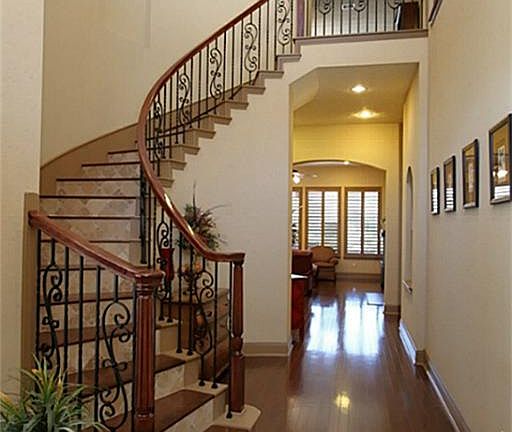 Enter through beautiful double doors 2 story foyer with wrought iron & wood spiral staircase
