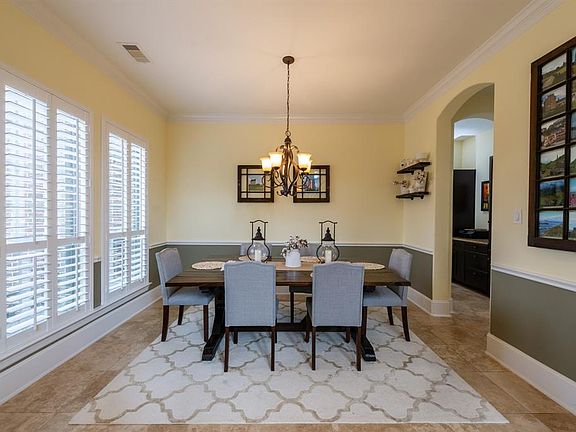 Dining with chair rail and shutters on the window