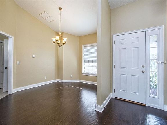Looking back towards entry door/foyer area and full dining room