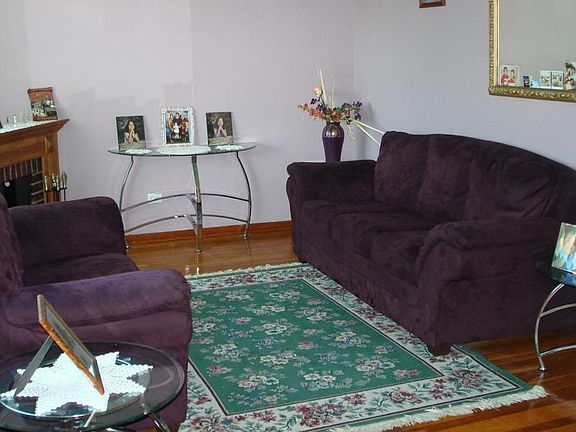 bright living room with hardwood floors and decorative fireplace