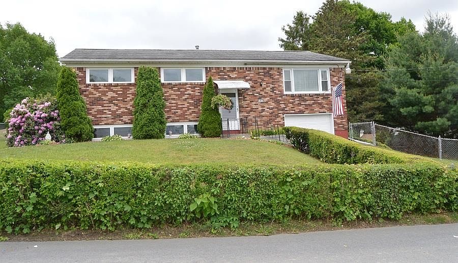 Brick and aluminum siding, landscaped