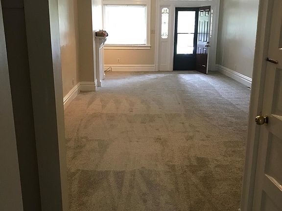 view from kitchen of dining room -living room front door