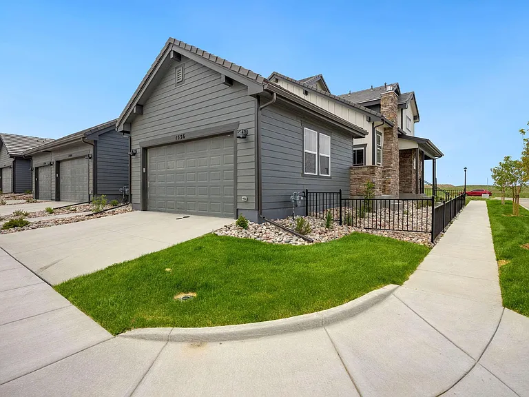 Exterior of townhome on a corner lot.
Plenty of light! 
Large 2 car garage!