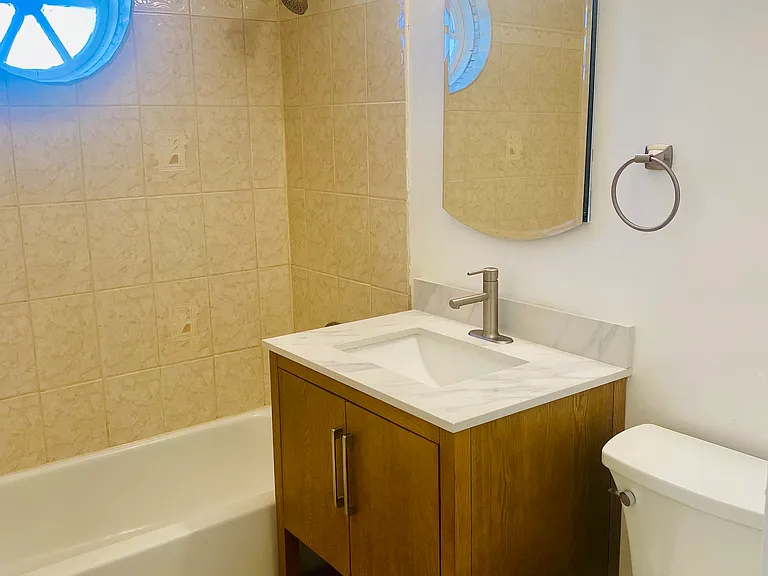 New vanity, mirror, light and latrine.