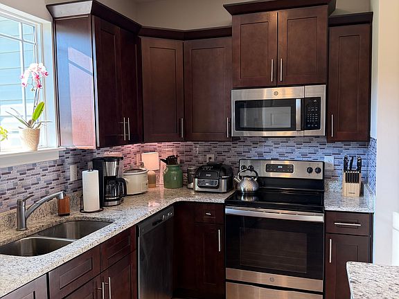 The modern kitchen is equipped with all necessary appliances and cookware needed.