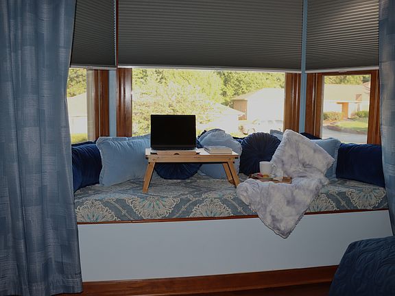 18 Sq. ft. bay window seat in queen bedroom with storage below.