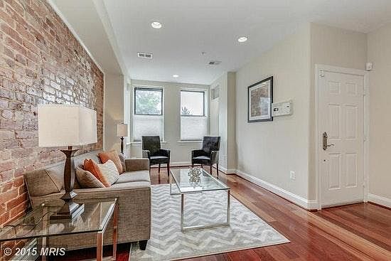 Open floor plan with exposed brick