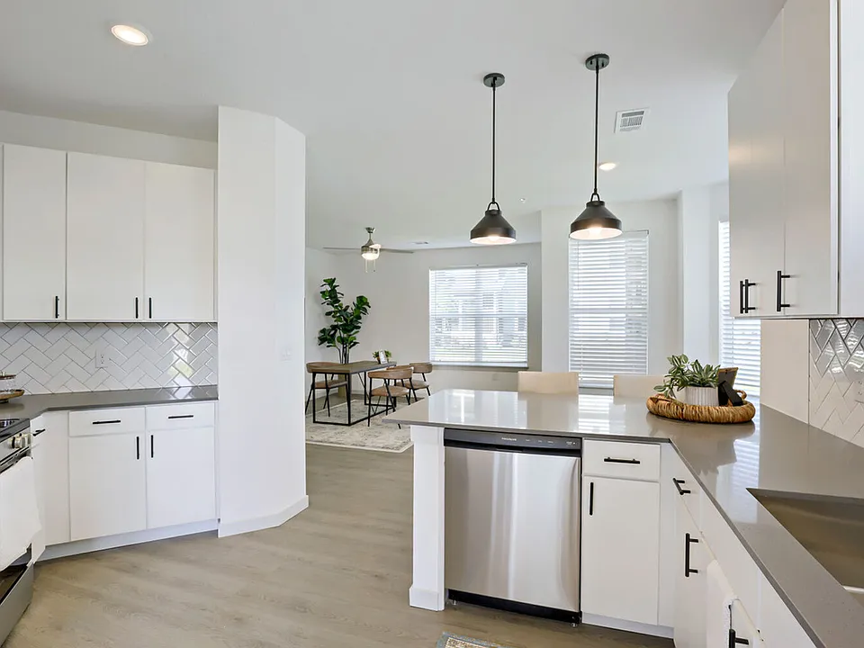 The open-concept kitchen flows directly into the dining area _ perfect for hosting or keeping an eye on the room while you cook. Garrett Harvest Junction West, Longmont, CO.