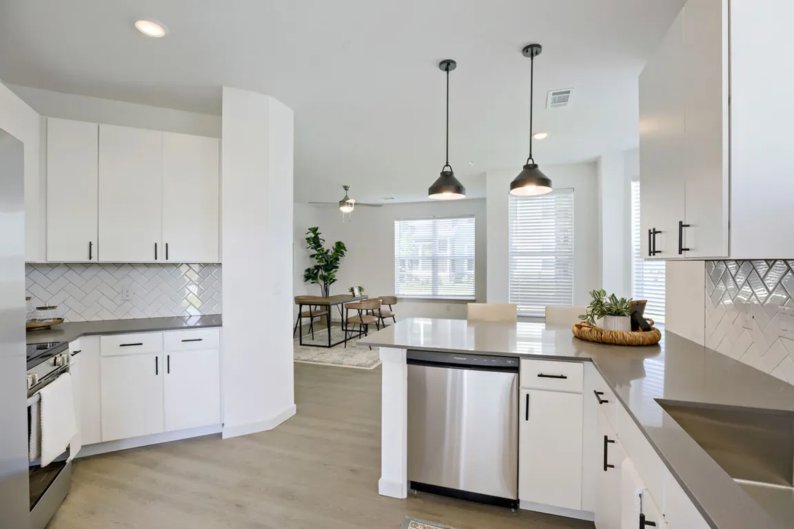 The open-concept kitchen flows directly into the dining area _ perfect for hosting or keeping an eye on the room while you cook. Garrett Harvest Junction West, Longmont, CO.