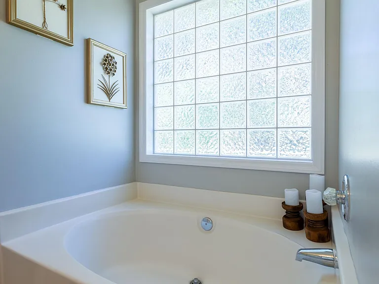 Bathroom 1 with hot tub and double vanity.