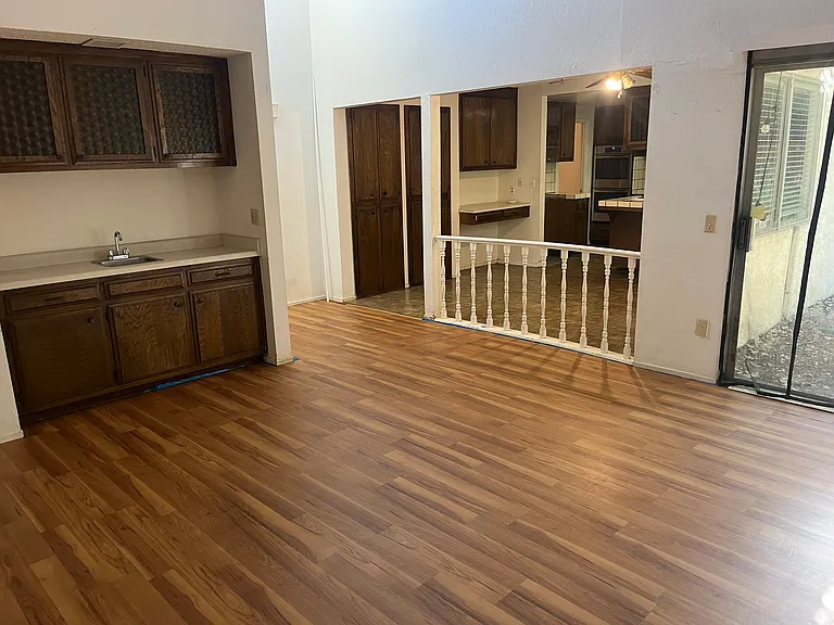 The family/entertaining room features a brick wood fireplace and a wet bar.