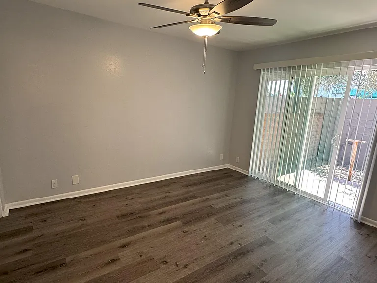 Second bedroom with sliding door to private backyard