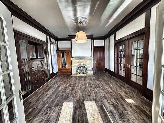 Dining room from the sun room. The living room is through the pocket doors on the right. Kitchen is through the brown door to the right of the fireplace.