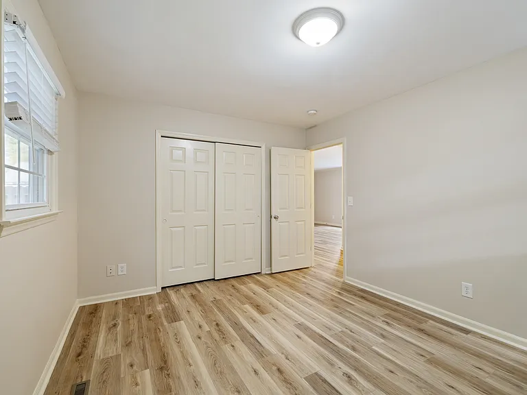 Bedroom 2; back corner of home; looking at closet; and door to hall