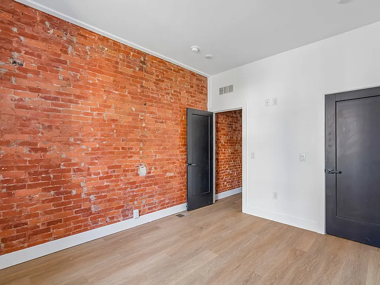 exposed brick wall in bedroom