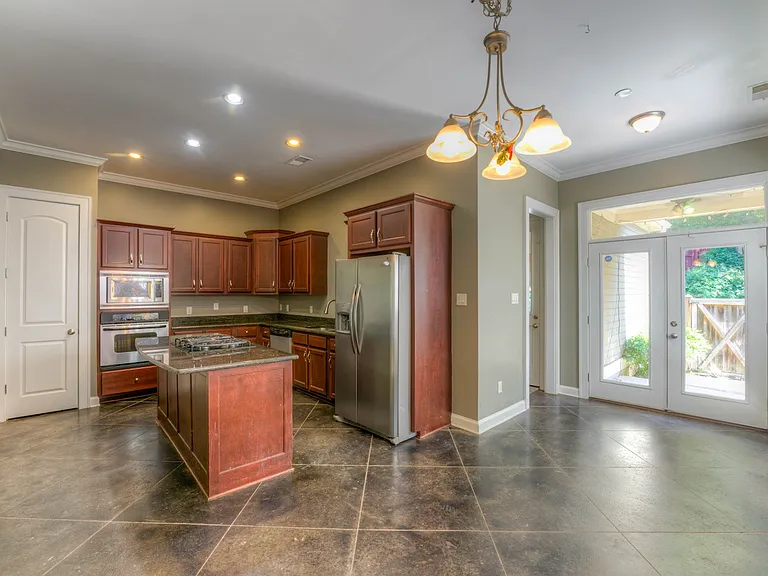 Dinning room open to the kitchen. Back door leads to patio of fenced in back yard. The hall way to the right of the back door leads to garage and laundry room.