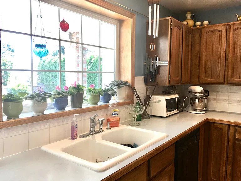 The kitchen faucet has been upgraded since this photo was taken.