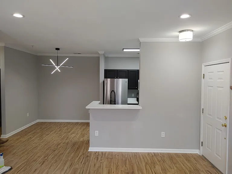 Newly installed light fixtures in both the kitchen and dining areas.