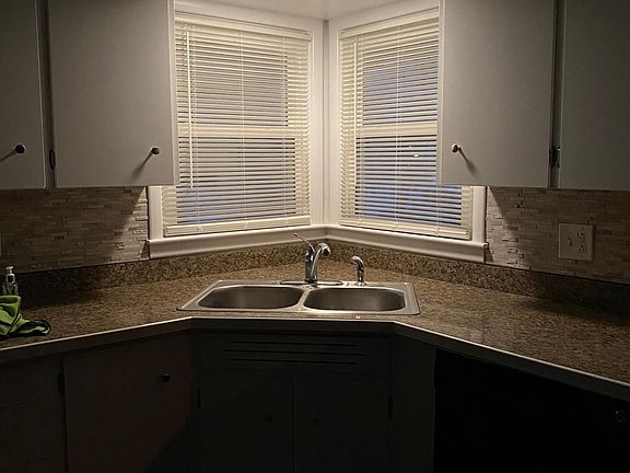 Kitchen looks out to covered deck and back yard.