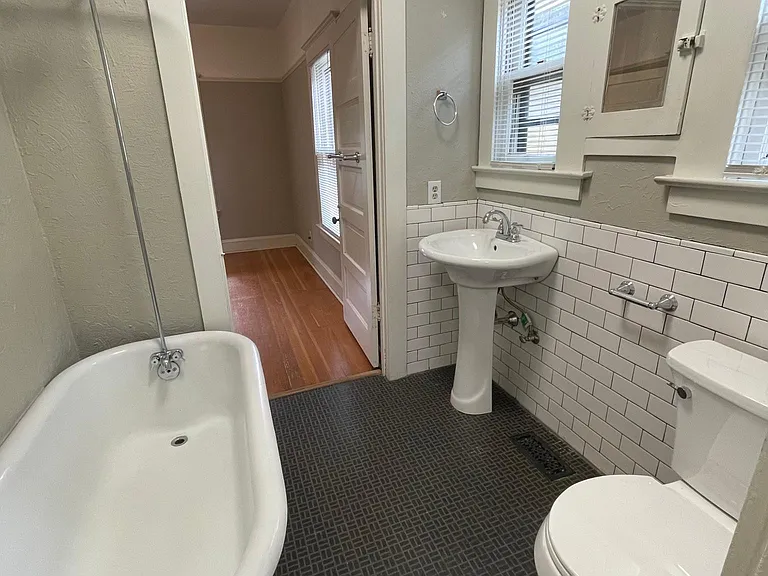 Bathroom with original claw tub.