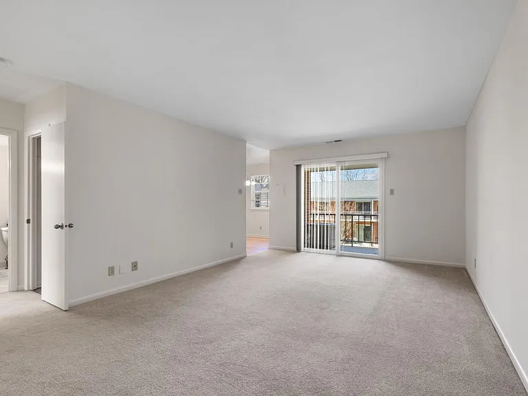 Spacious Living Room with Sliding Glass Doors Leading to Private Patio or Balcony