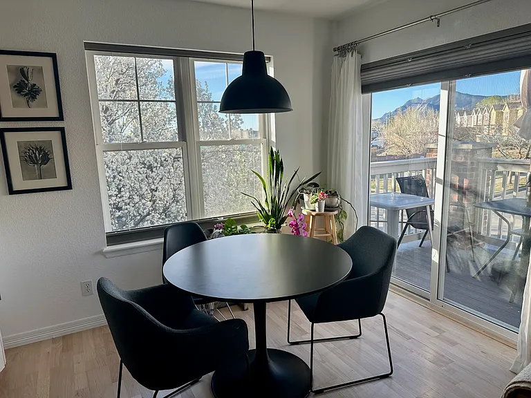 Dining area with floor to ceiling sliding screened door and direct access to private deck.