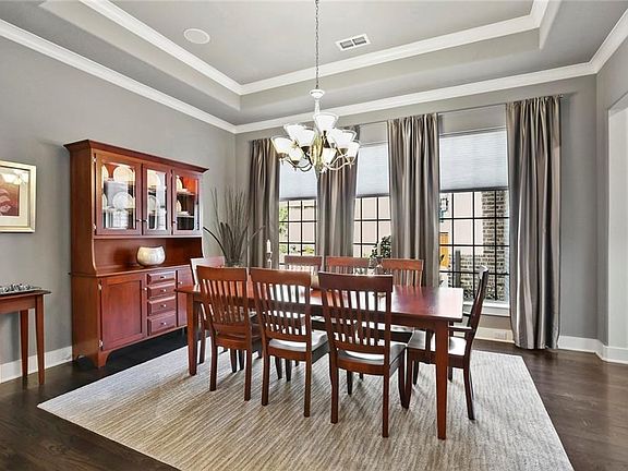 Formal Dining with built in ceiling speakers and tasteful designer light fixture. Wide base moldings and trims in contemporary clean style throughout this home.