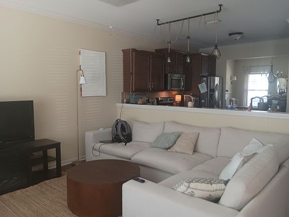 View from furnished living room through kitchen to dining room