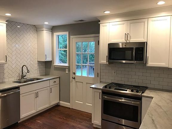 Kitchen with Marble Countertops and New Stainless Steel Appl
