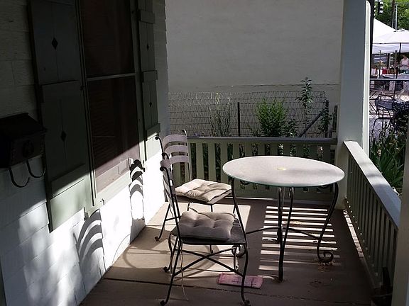 Sunny porch and inviting yard