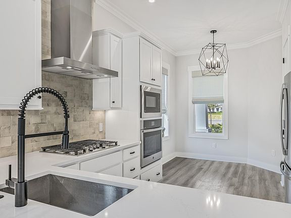 Kitchen has a sunny breakfast nook and pantry. Large french door refrigerator. Beautiful grey/blue brick backsplash extends all the way to the ceiling